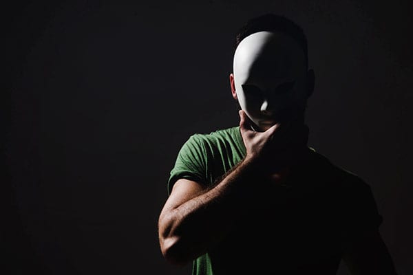 La Sombra Man-wearing-mask-in-dark