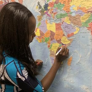 Emily Kamunde-Osoro coloring in Kenya to note achievement of 2019 Global Coaching Survey 100 Club.