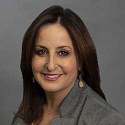 Ann Rindone PCC headshot photo, smiling woman with brown hair
