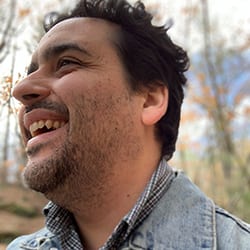 Casey Perkins-Lawrence headshot photo, smiling man with dark hair outside