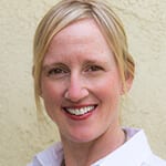 Karyn Danielle Chylewski PCC headshot photo, smiling woman with blond hair wearing light collared shirt in front of cream colored wall