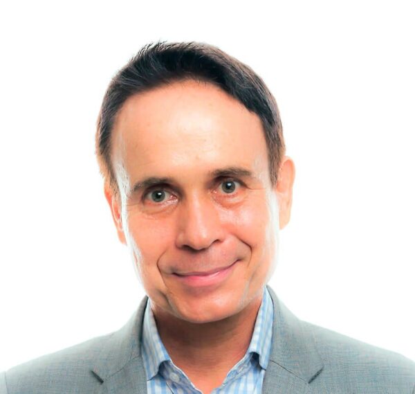 Jean-Francois Cousin MCC headshot photo, smiling man wearing light suit jacket and light colored collared shirt in front of white background