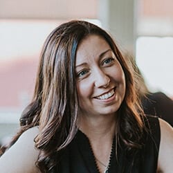 Jennifer Jenn Wicks PCC CEC headshot photo, woman smiling with brown hair wearing a black top