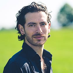 Simon Blackhall PCC headshot photo, man with dark hair and collared shirt standing outside