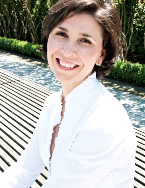 Sophie Bizeul MCC PCC headshot photo, woman smiling wearing a white top sittting outside