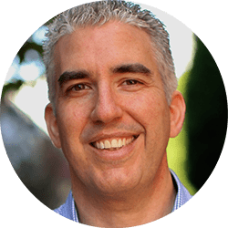 Marc A Wolfe ACC headshot photo, smiling man with gray hair wearing a collared shirt outside
