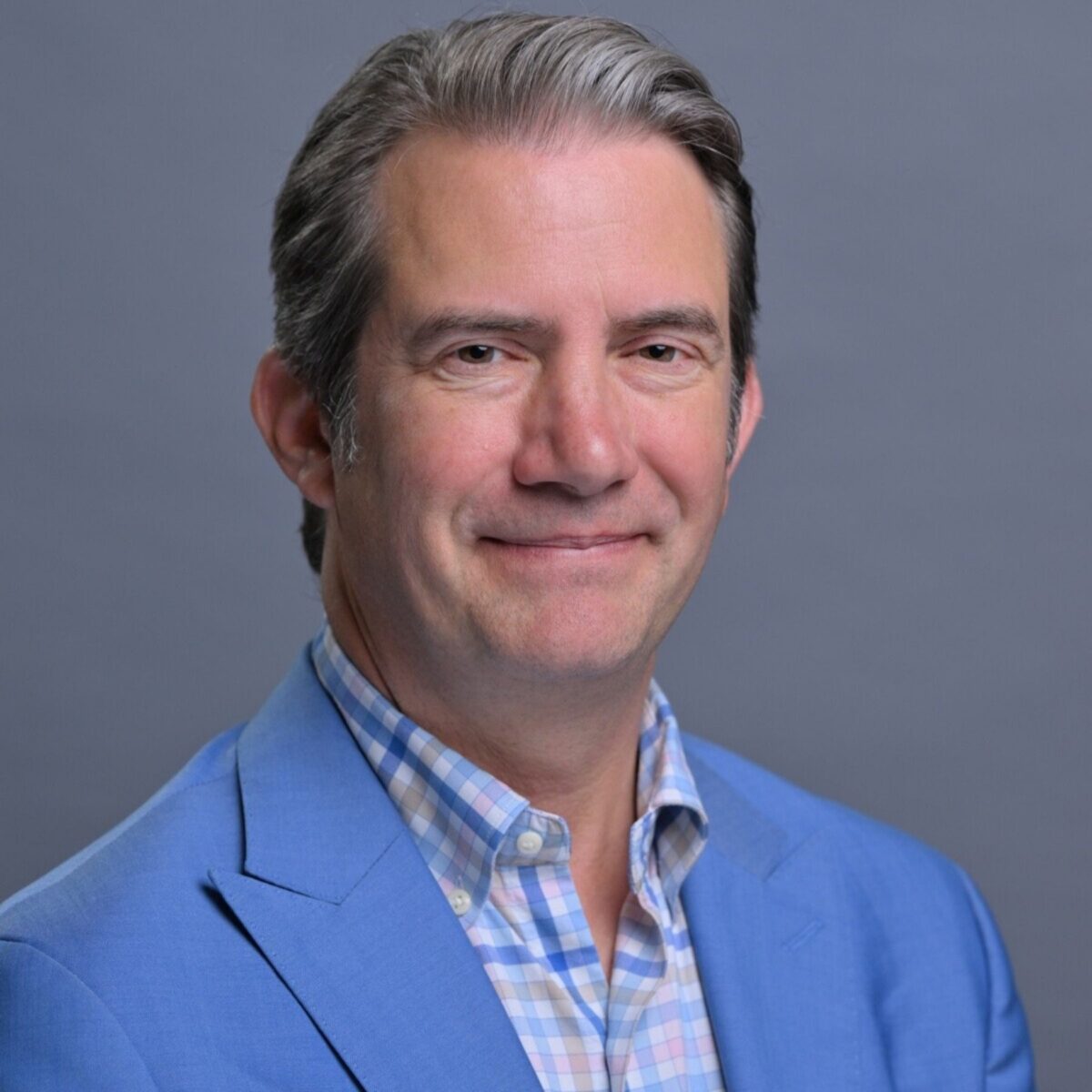 Headshot of Woody Woodward, PCC with the International Coaching Federation. Known for co-founding and leading NYU's Master of Science in Executive Coaching and Organizational Consulting (ECOC) program and expertise in organizational consulting at PricewaterhouseCoopers Consulting (PwC) and project management for IBM Business Consulting Services.