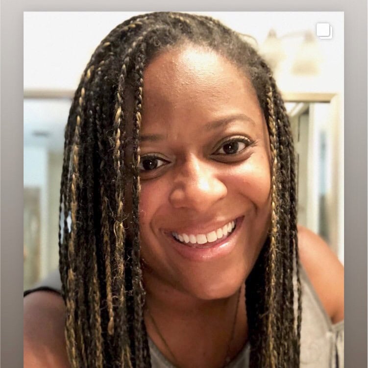 Jessica Carry ACC headshot photo, smiling woman with braided hair wearing a light top