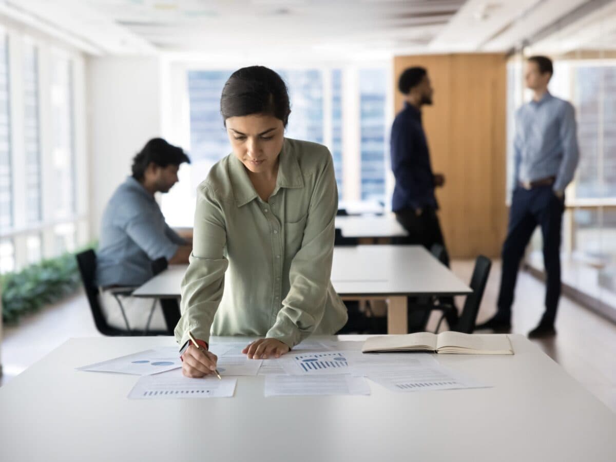 A woman is looking through the ethical resources in an office.
