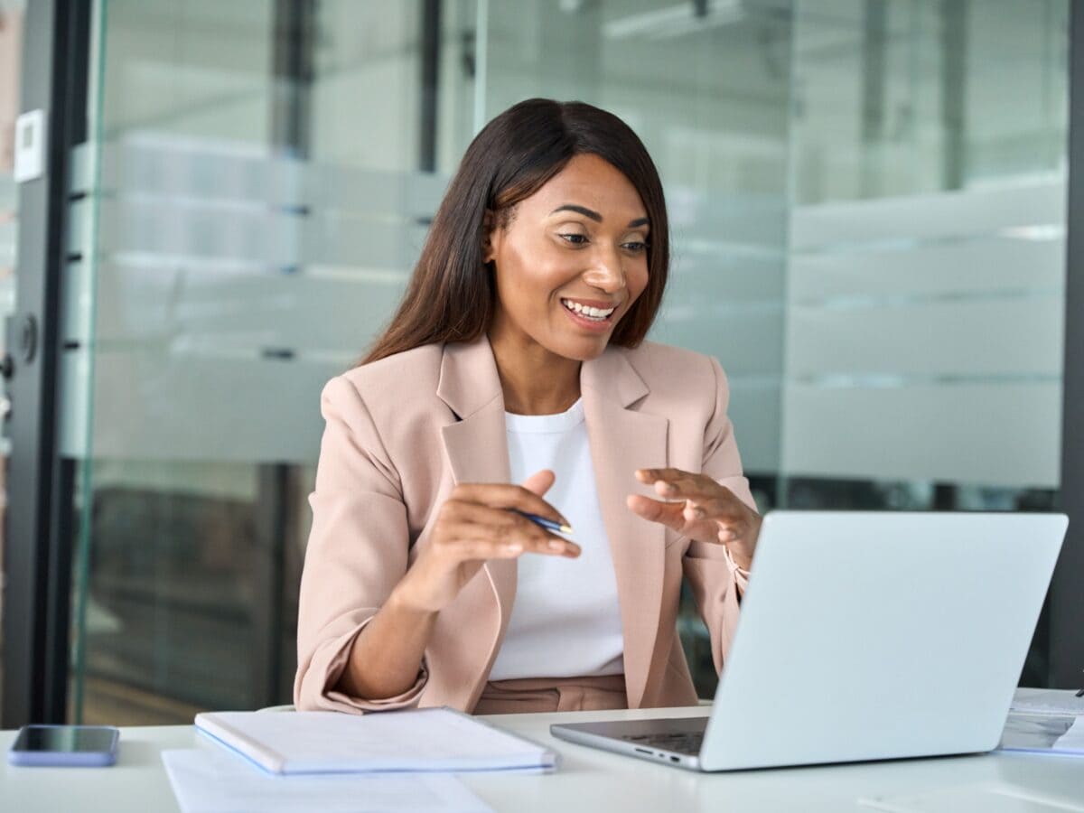 Woman working with laptop talking to a client