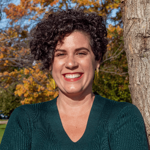 Headshot of a woman in front of a tree
