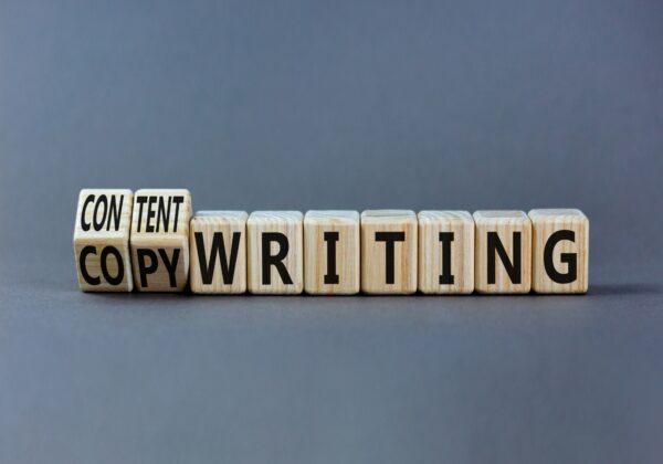 Wooden cubes on a gray background that spell out Content Writing.