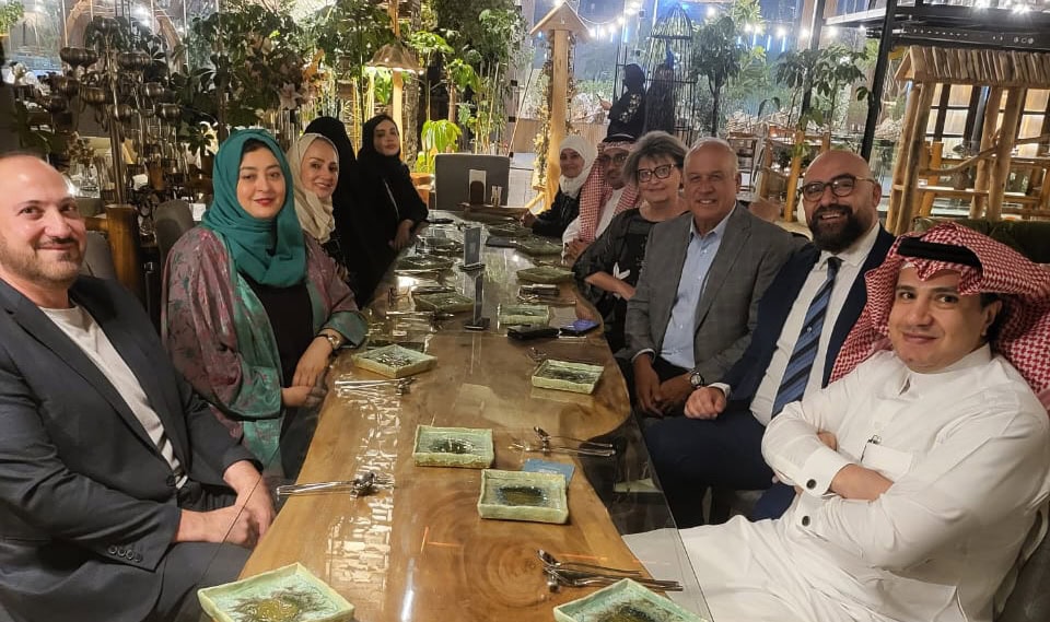 ICF global leaders seated at a dinner table with members of the ICF Saudi Arabia Chapter, reflecting community, cultural connection, and shared commitment to advancing coaching in the region.
