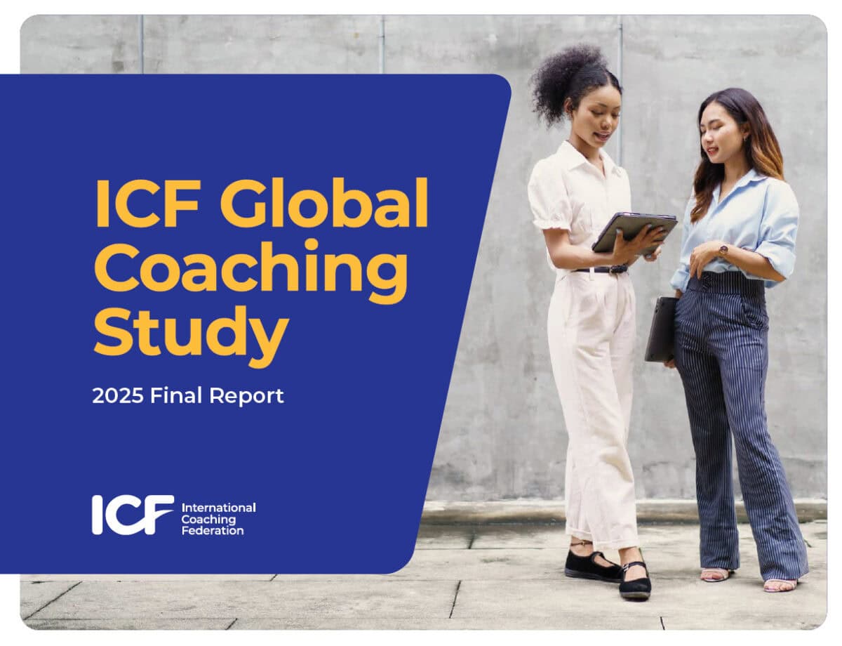 Cover image of 2025 ICF Global Coaching Study. Two young women standing, looking at data on an electronic tablet.