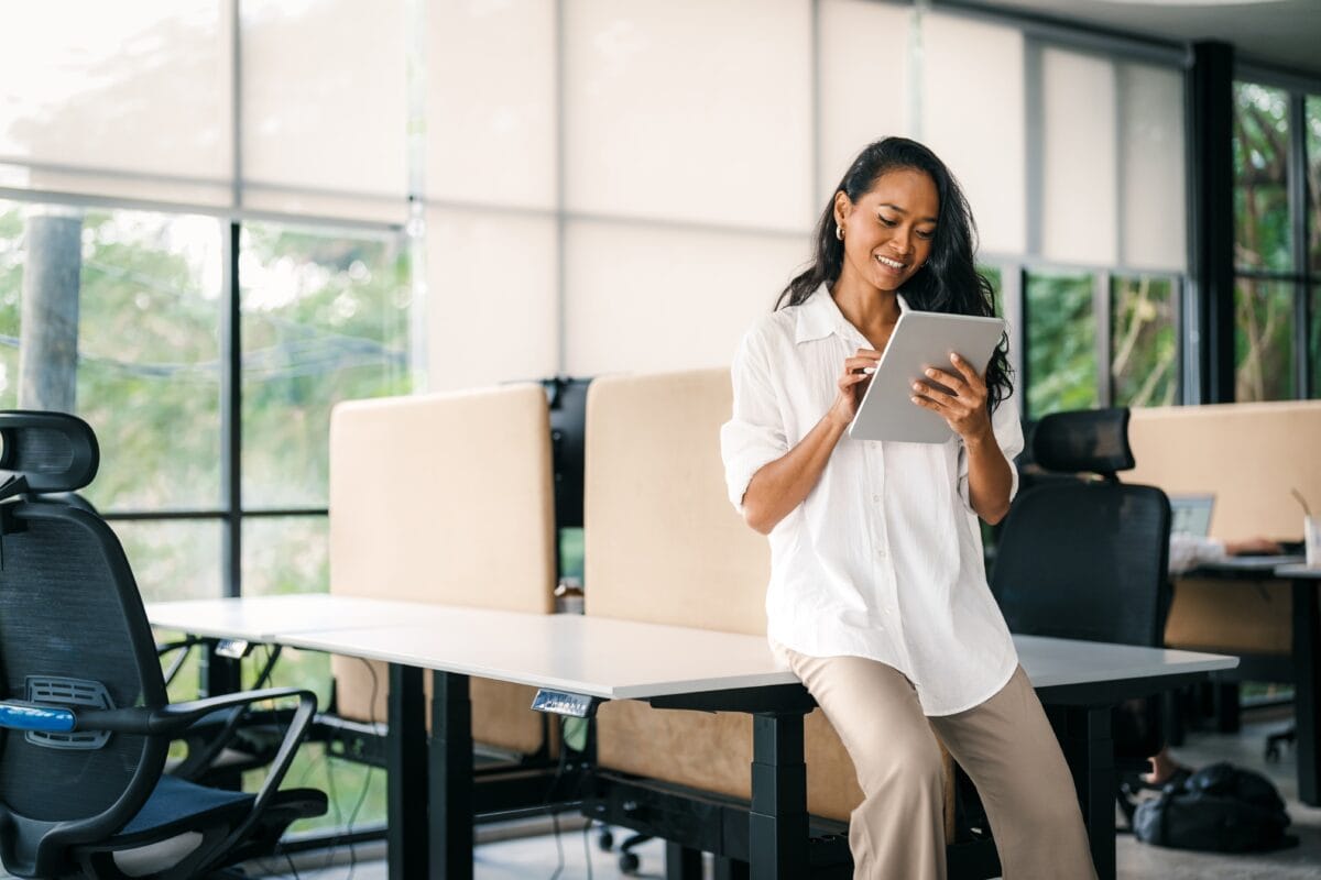 Professional standing in an office while using a tablet