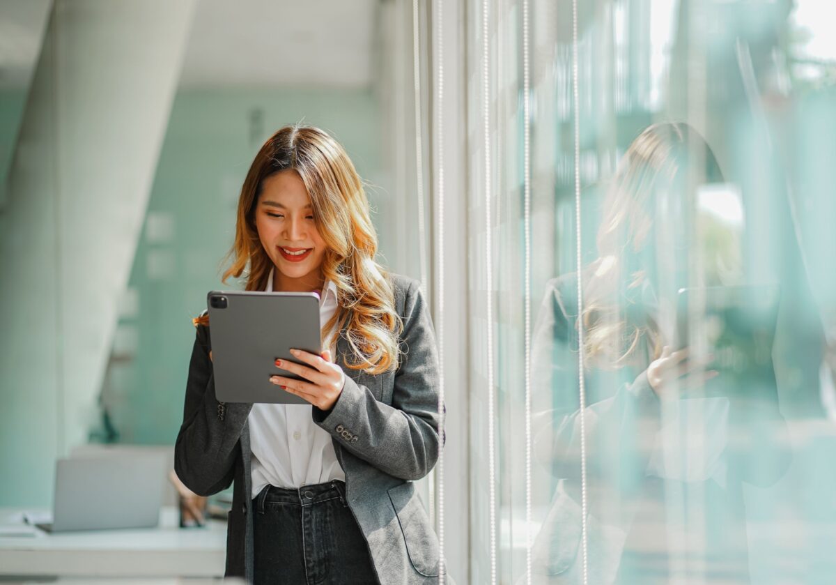 Professional using a tablet to support AI-enabled coaching and communication.
