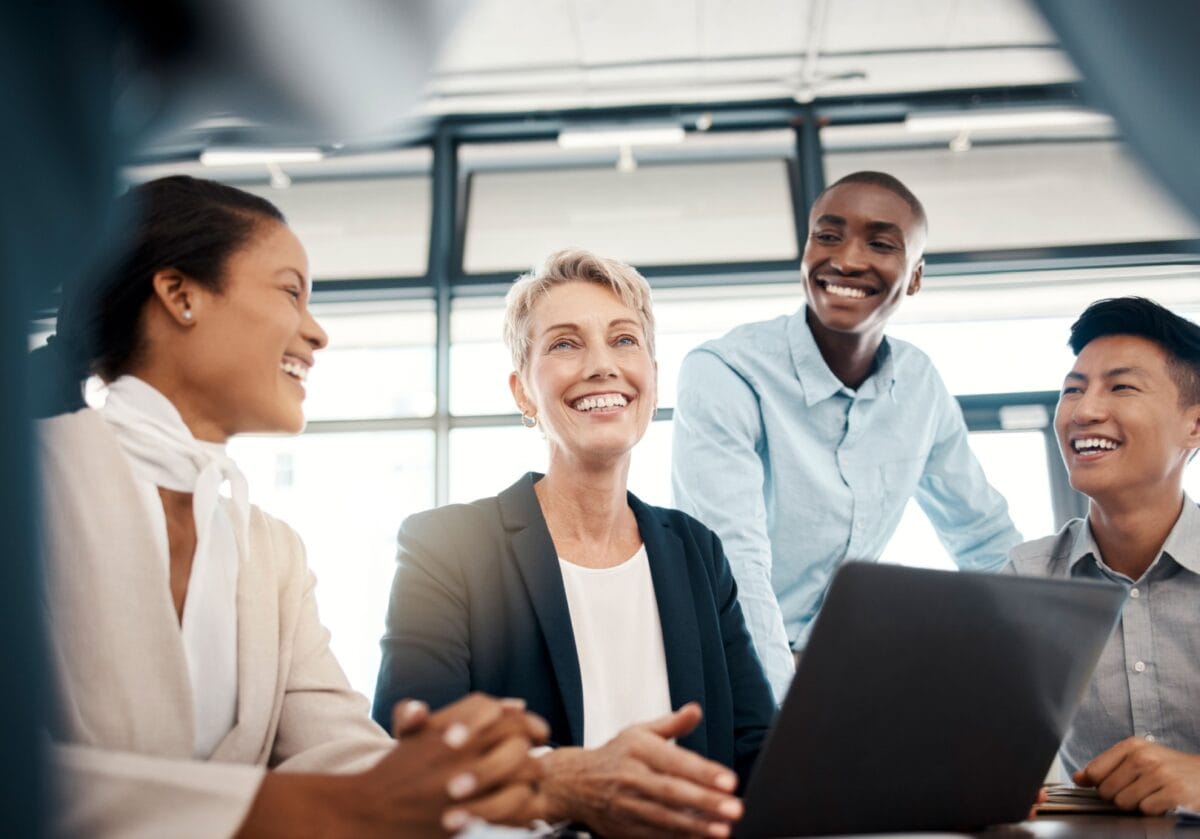 Diverse professionals collaborating in a modern workplace, representing collaborative ecosystems and the future of coaching.