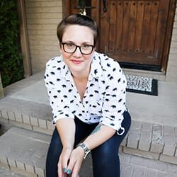 Kristena Shiflett ACC headshot photo, brown haired woman sitting on steps outside smiling