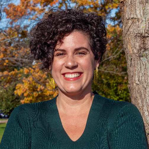 Headshot of a woman in front of a tree