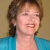 Dr. Shelley Carson headshot photo, smiling woman with short hair wearing a blue sweater