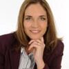 Stacey Ashley PCC headshot photo, smiling woman with dark hair wearing dark blazer with her hand on her chin