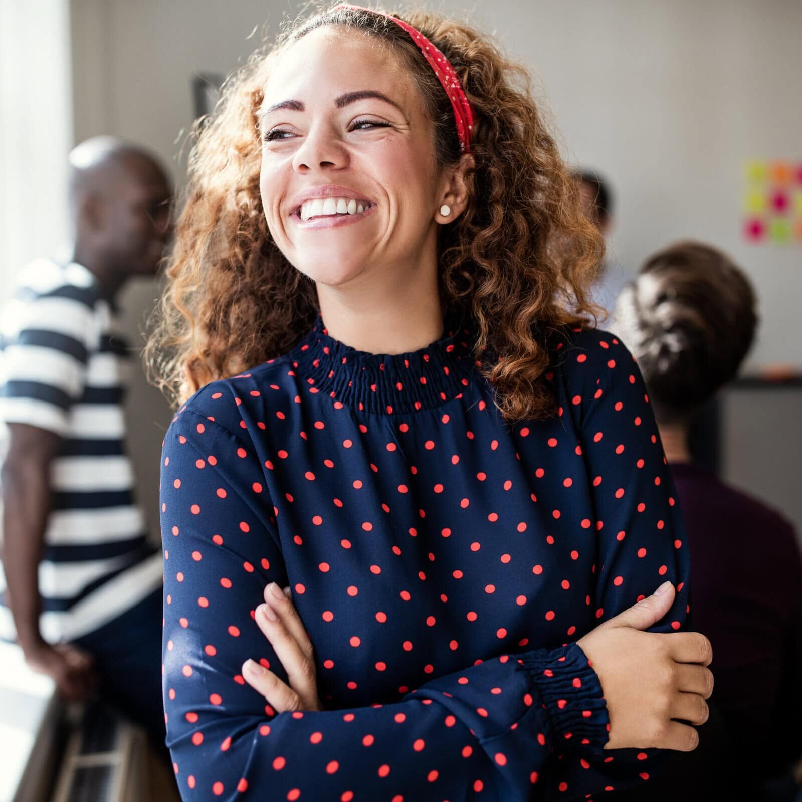 Laughing,Young,Female,Designer,Standing,With,Her,Arms,Crossed,In