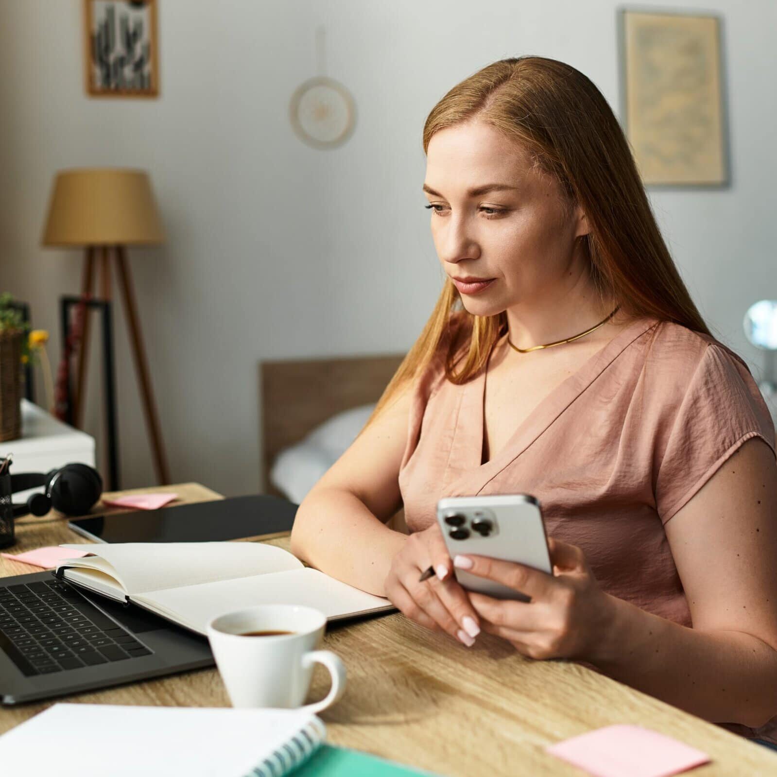 A,Young,Woman,Sits,Quietly,At,Her,Desk,,Focused,On