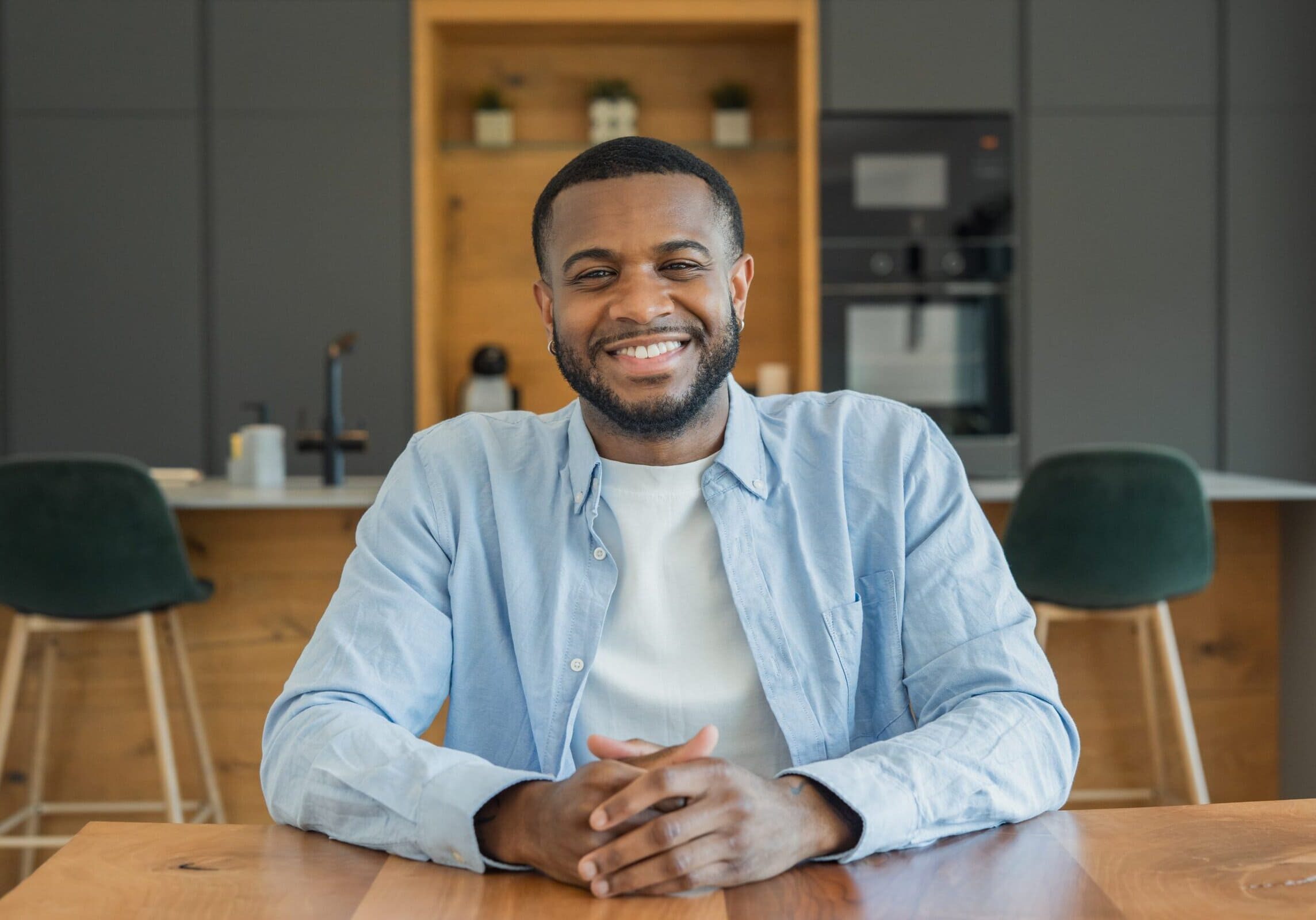 Man sitting at a desk in a common area of an office building after earning his css.