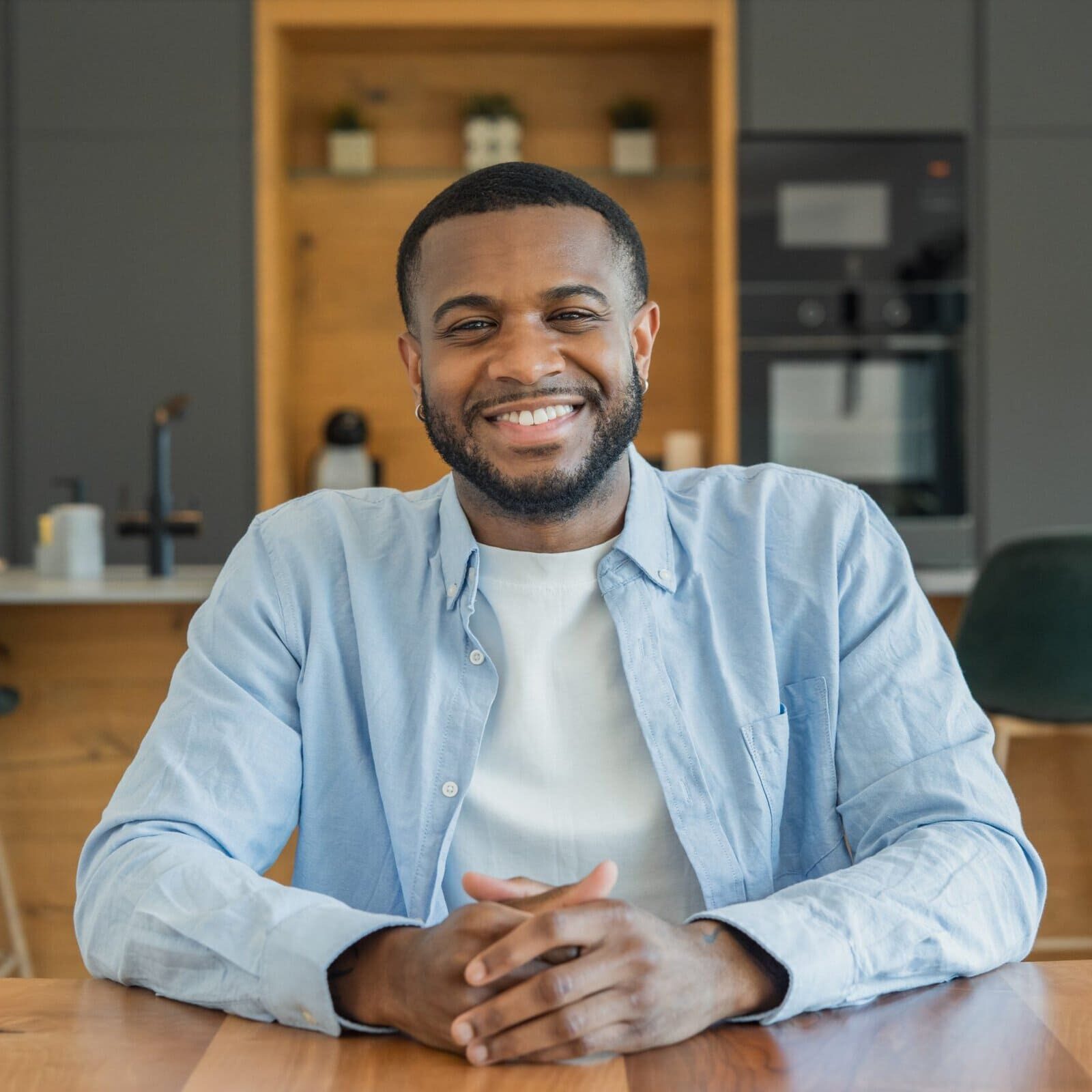Man sitting at a desk in a common area of an office building after earning his css.