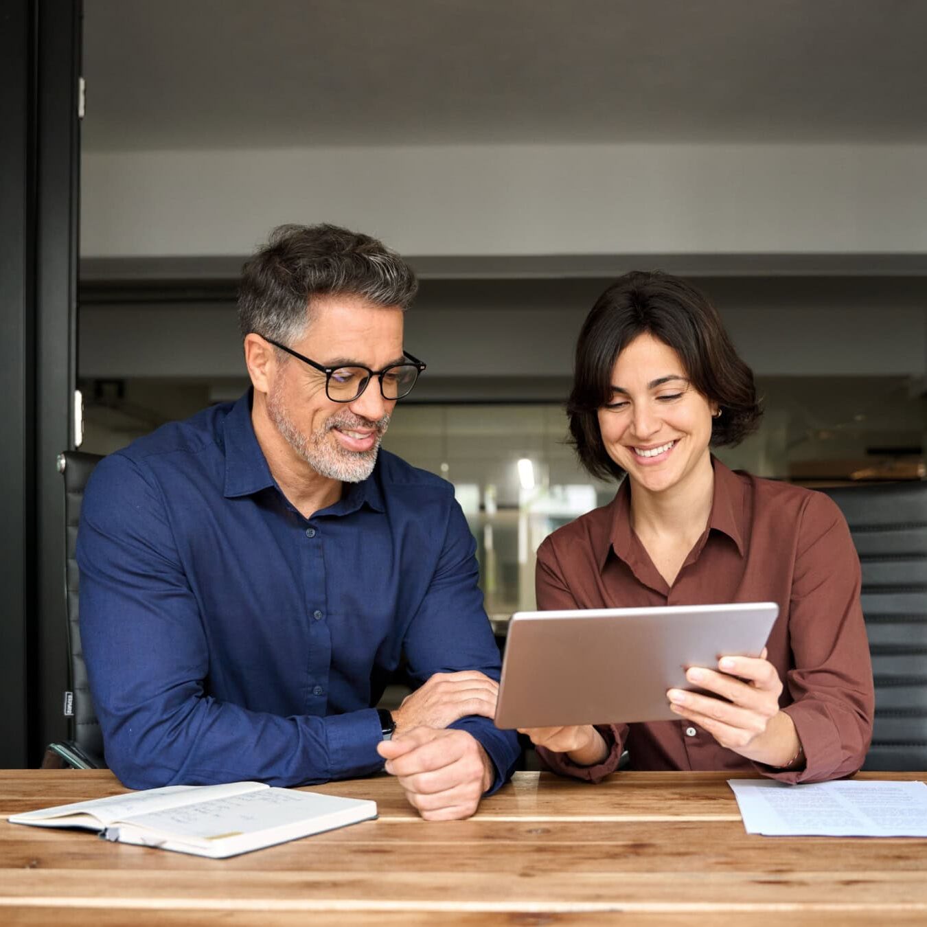 icf-featured-topics-and-resources Two people look at a tablet to view the ICF Featured events
