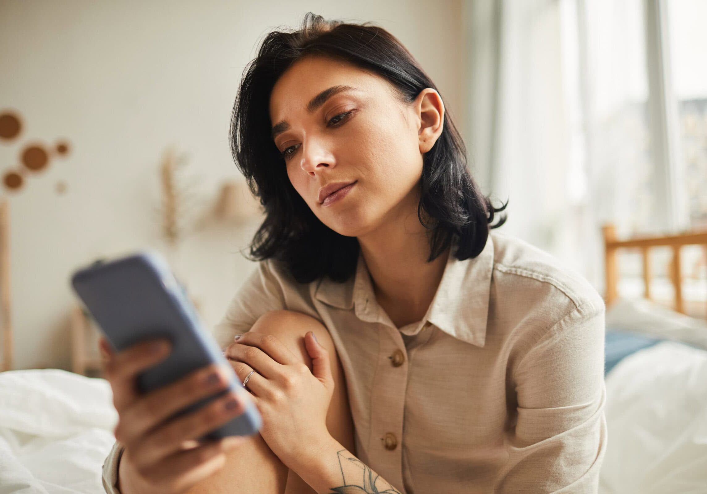 Warm-toned,Portrait,Of,Modern,Young,Woman,Using,Smartphone,While,Sitting