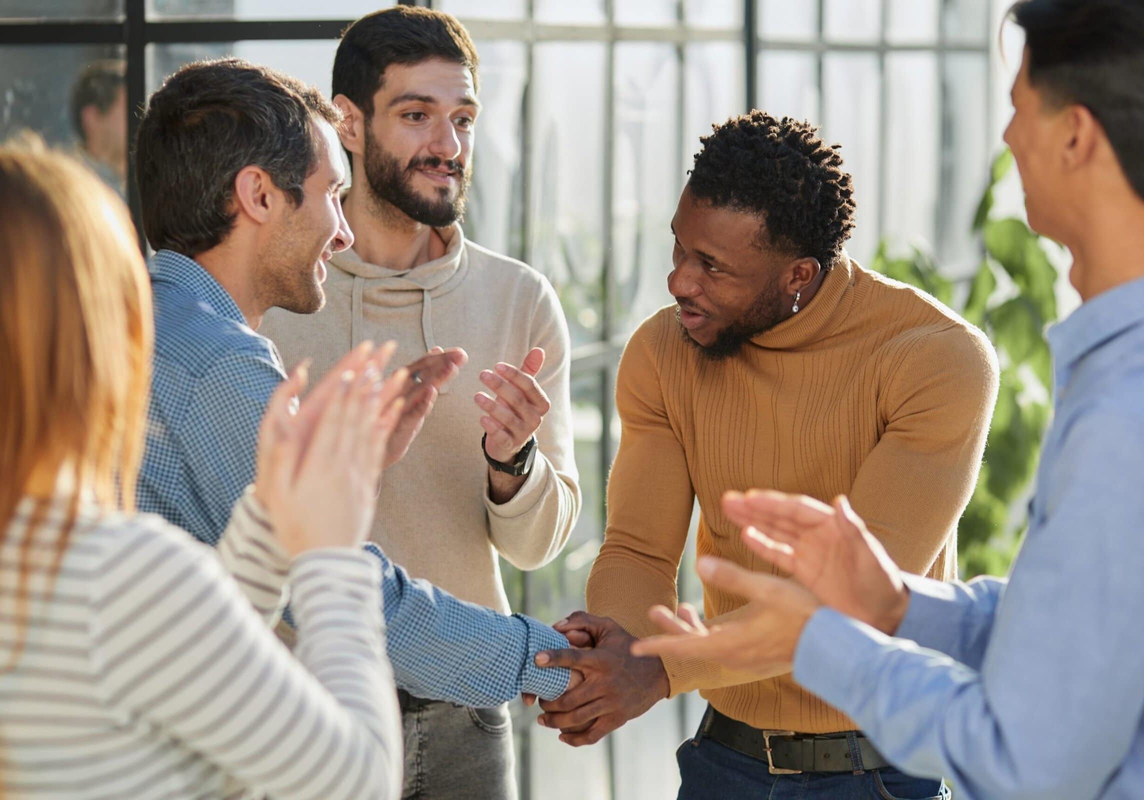 Smiling,Multiethnic,Friend,Getting,Acquainted,In,Office,Corridor