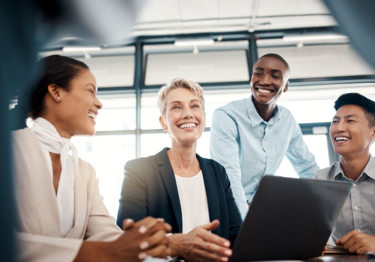 Diverse professionals collaborating in a modern workplace, representing collaborative ecosystems and the future of coaching.