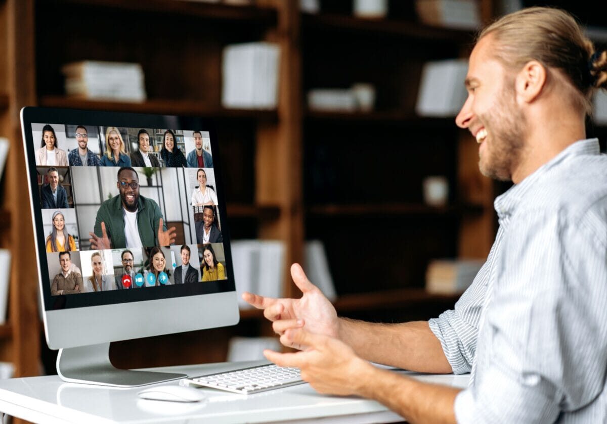 Professional engaging in a virtual coaching session with a diverse group on screen, illustrating cultural intelligence in coaching and the future of coaching
