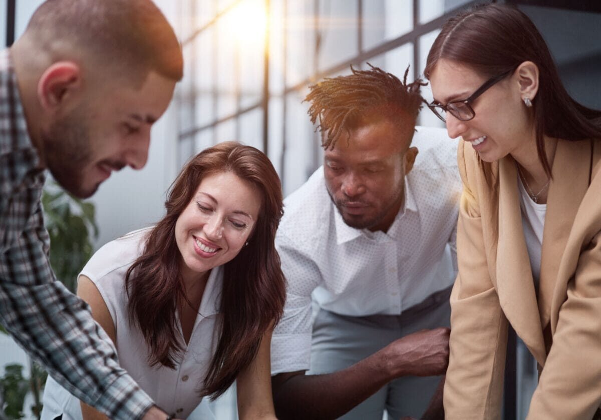 Professionals collaborating to design a coaching program during a team planning session.