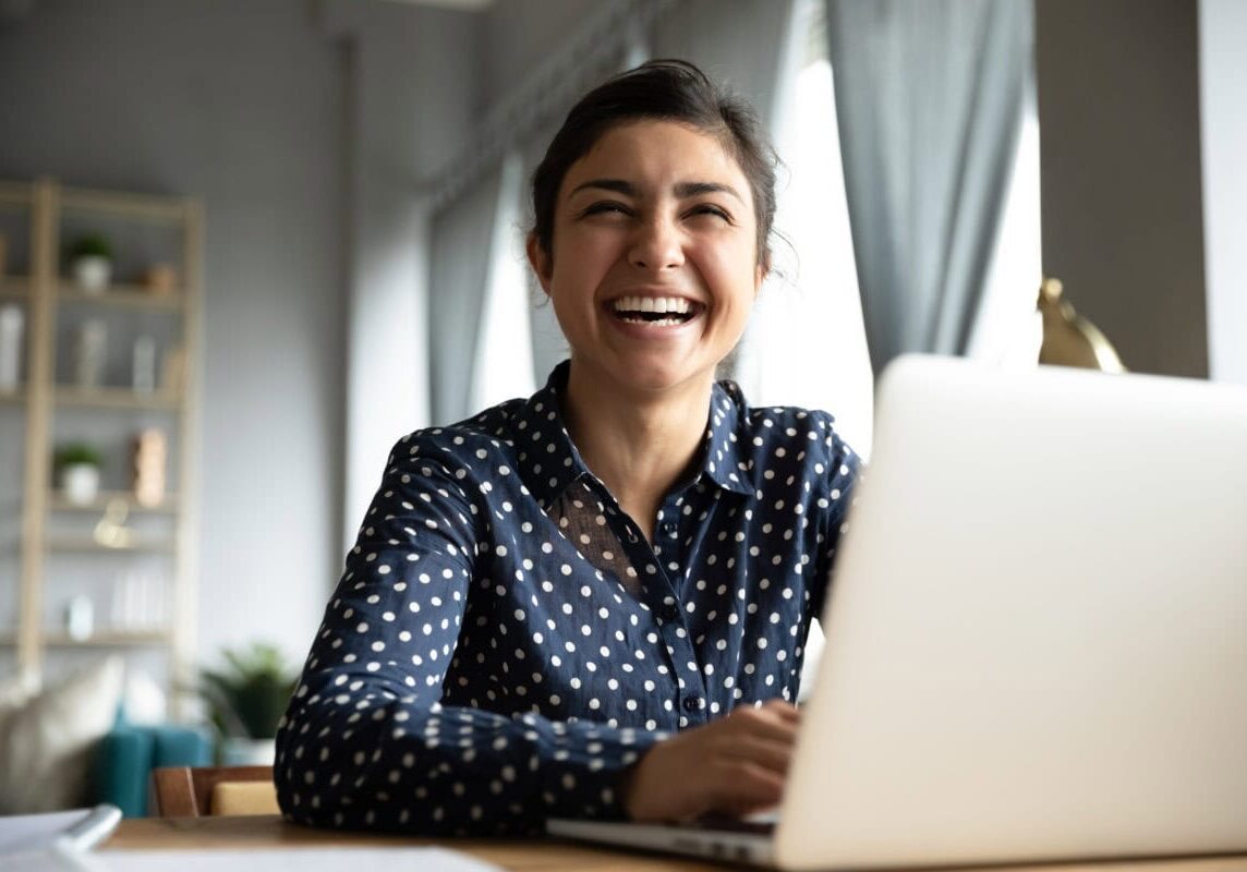 smiling coach at a laptop